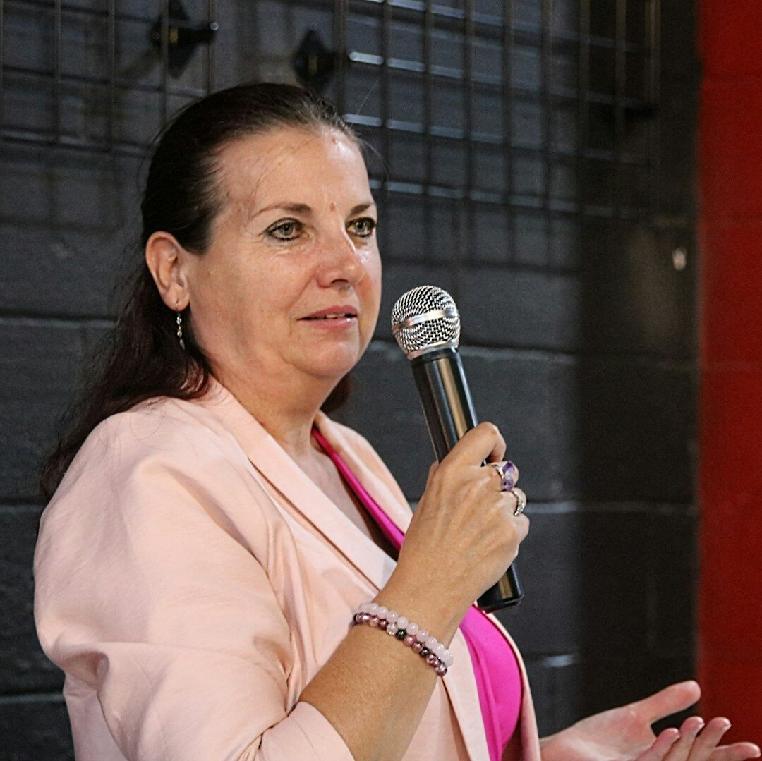 Studio portrait of a Belgian woman in her forties presenting a business TV show